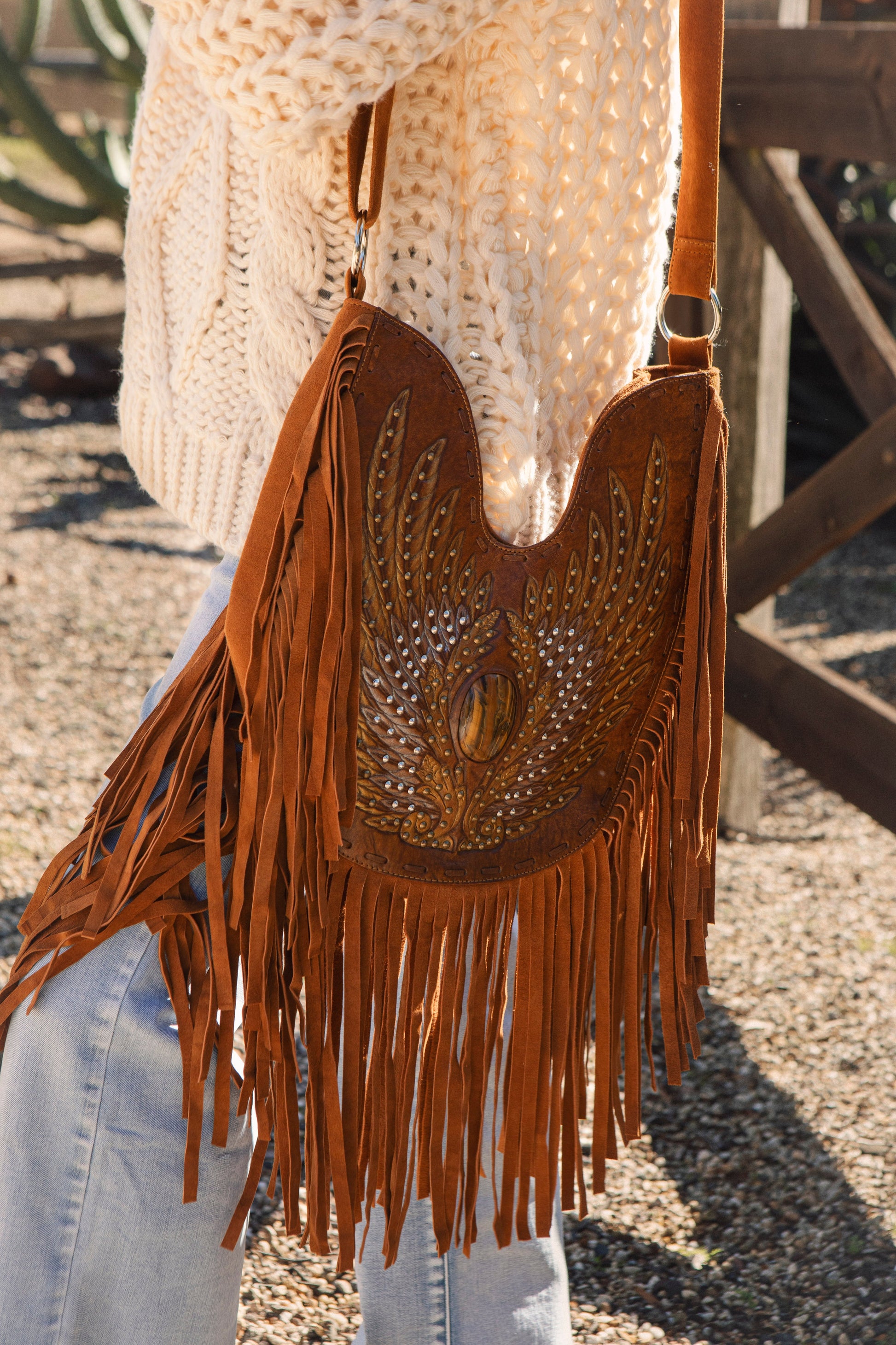 Jaz Shoulder Bag features hand tooled leather and statement tassels